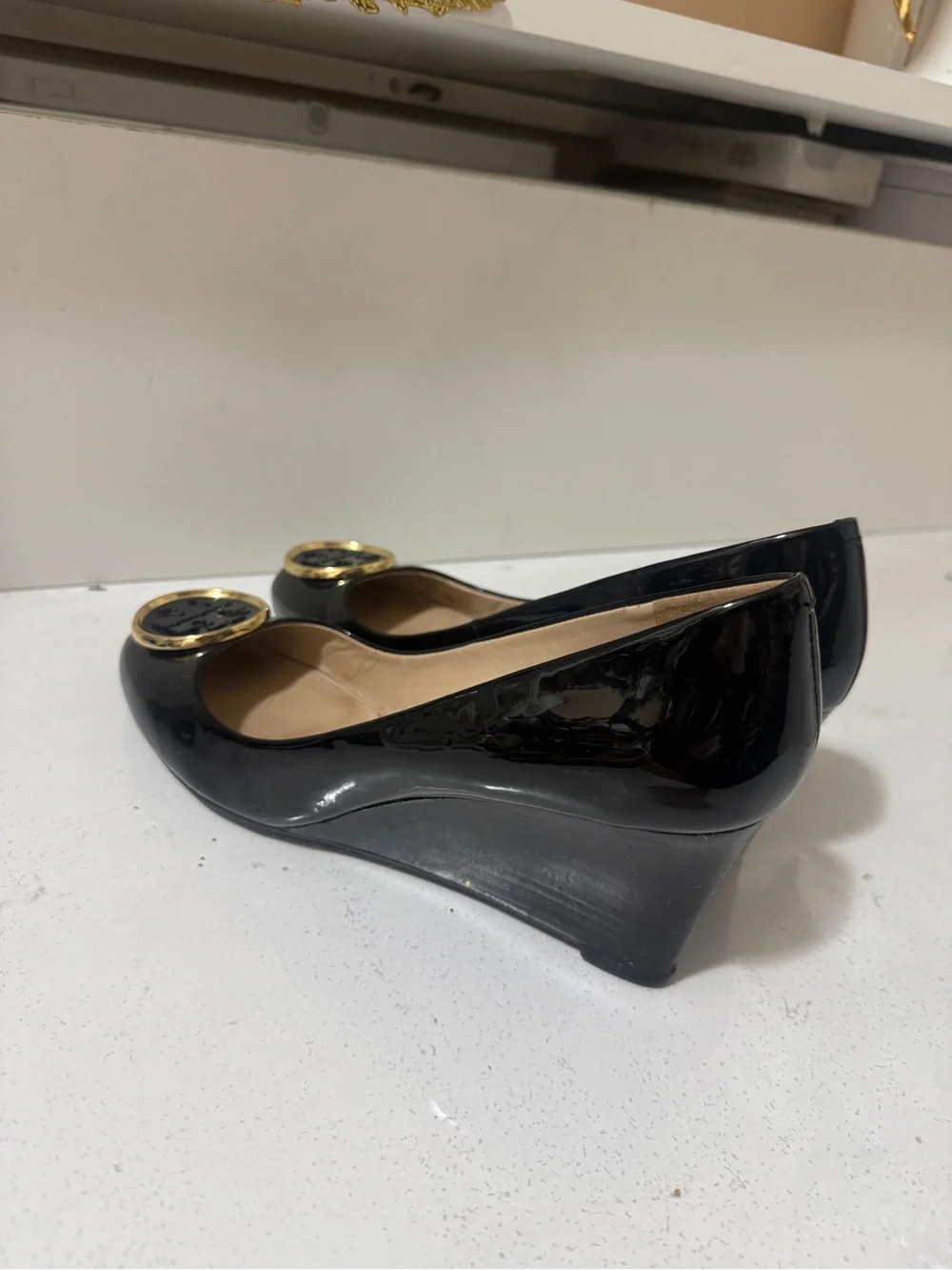 Tory Burch Black Patent Leather Wedges with Gold Logo Medallions